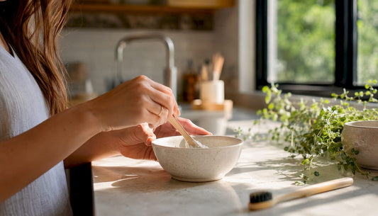 Hands applying baking soda paste on toothbrush