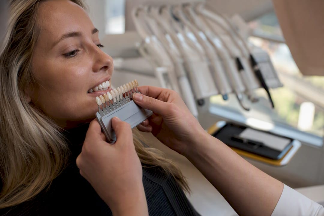Close-up of tooth shade guide next to teeth