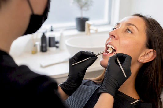 Dental tools inspecting brown tooth stain