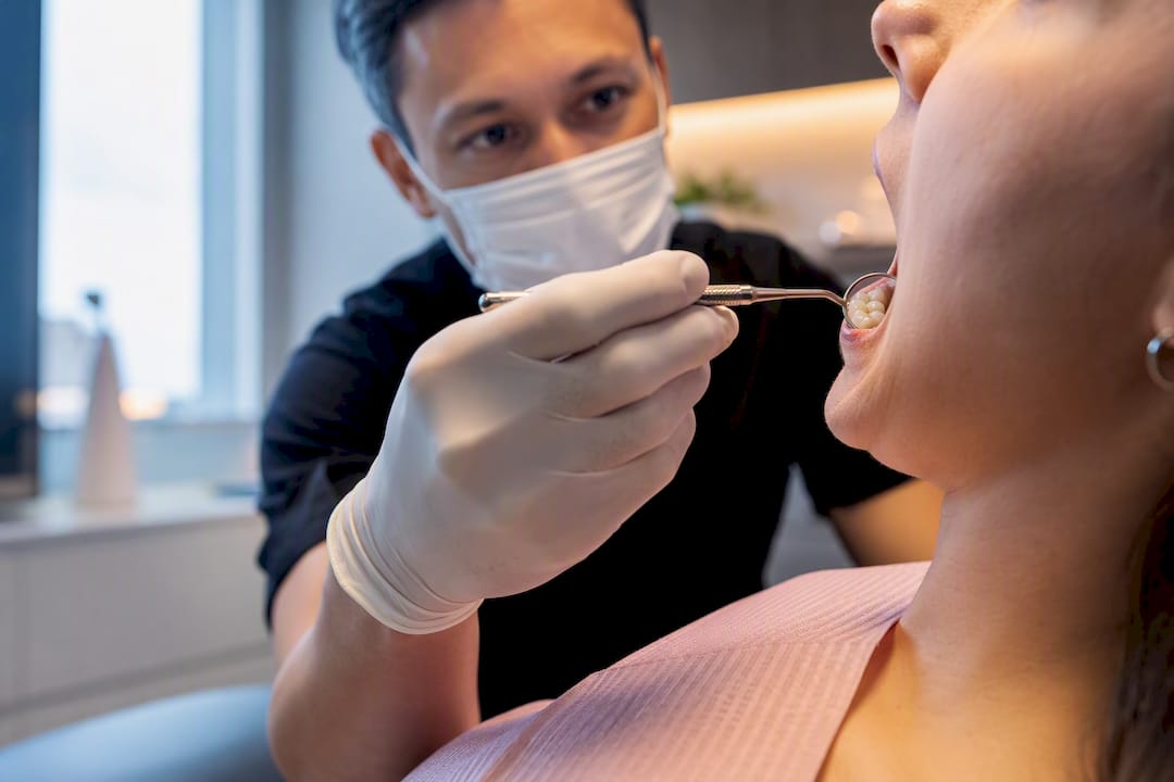 Dentist examining tooth before whitening
