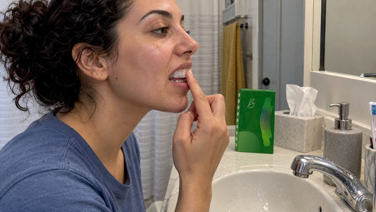 Woman pressing a whitening strip into place