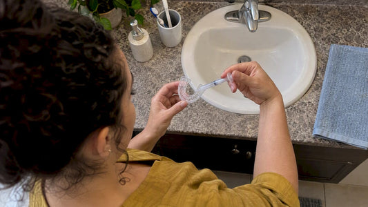 Woman preparing a dental tray with desensitizing gel