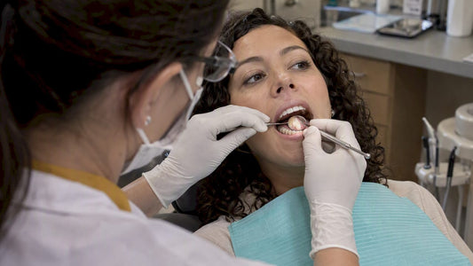 Dentist examining a receding gumline